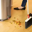 Sweep debris toward the automatic vacuum - No dustpan needed