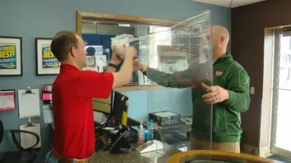 Cashiers behind buffet style sneeze guards