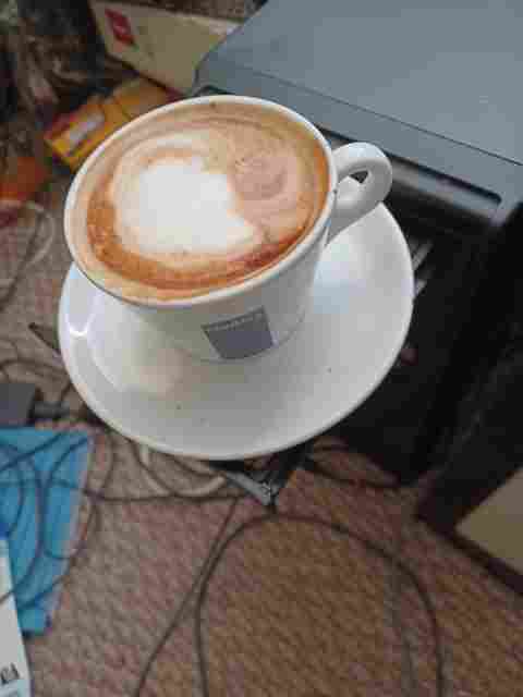 Cappuccino in the computer's coffee cup holder