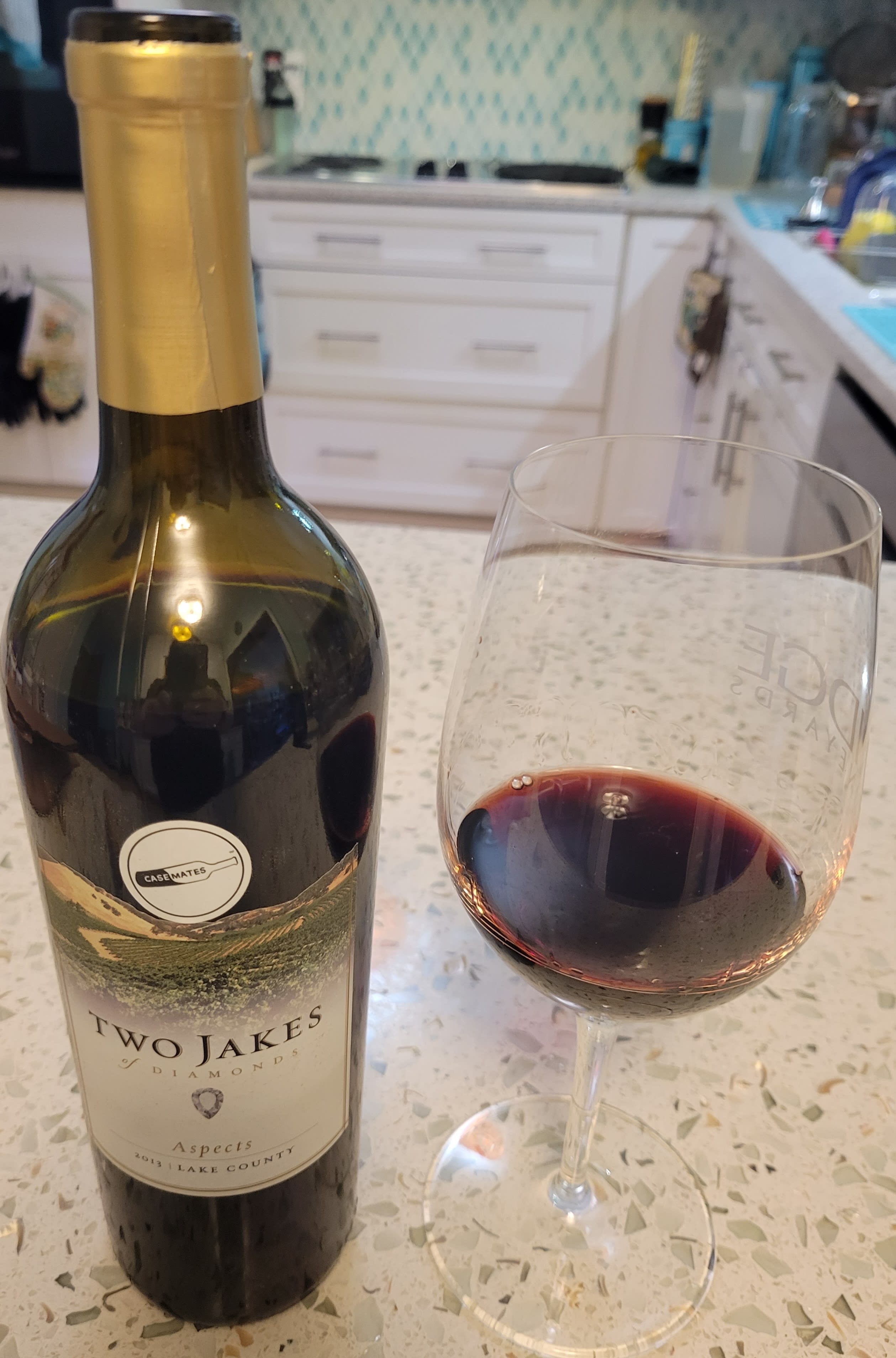 Aspects wine bottle and glass of wine