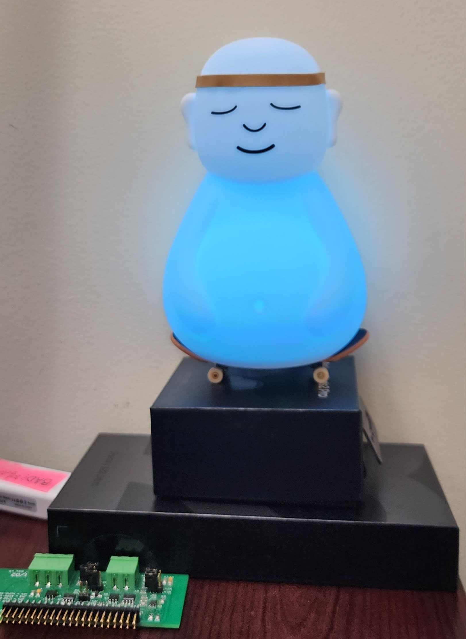 Best I can do is a glowing Buddha riding a skateboard atop boxes of materialistic goods.