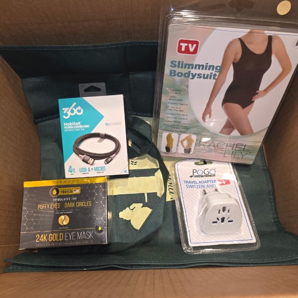 The 4 items (not including the tote): 1. A slimming bodysuit for a woman (size large); 2. An outlet adapter just for Switzerland; 3. Gold eye mask; and 4. A USB-Micro USB cable) 