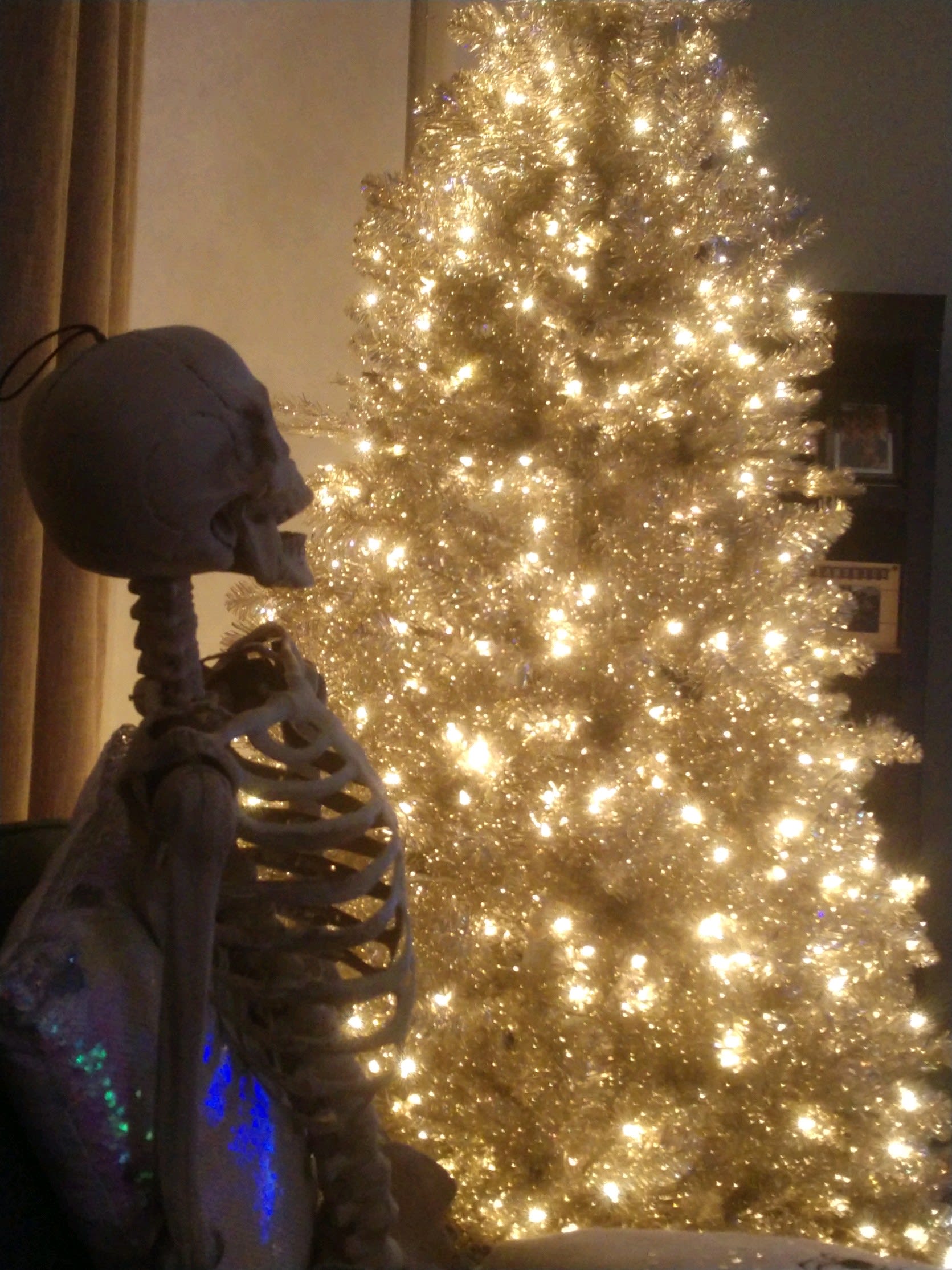 Skeleton looking at the Christmas tree