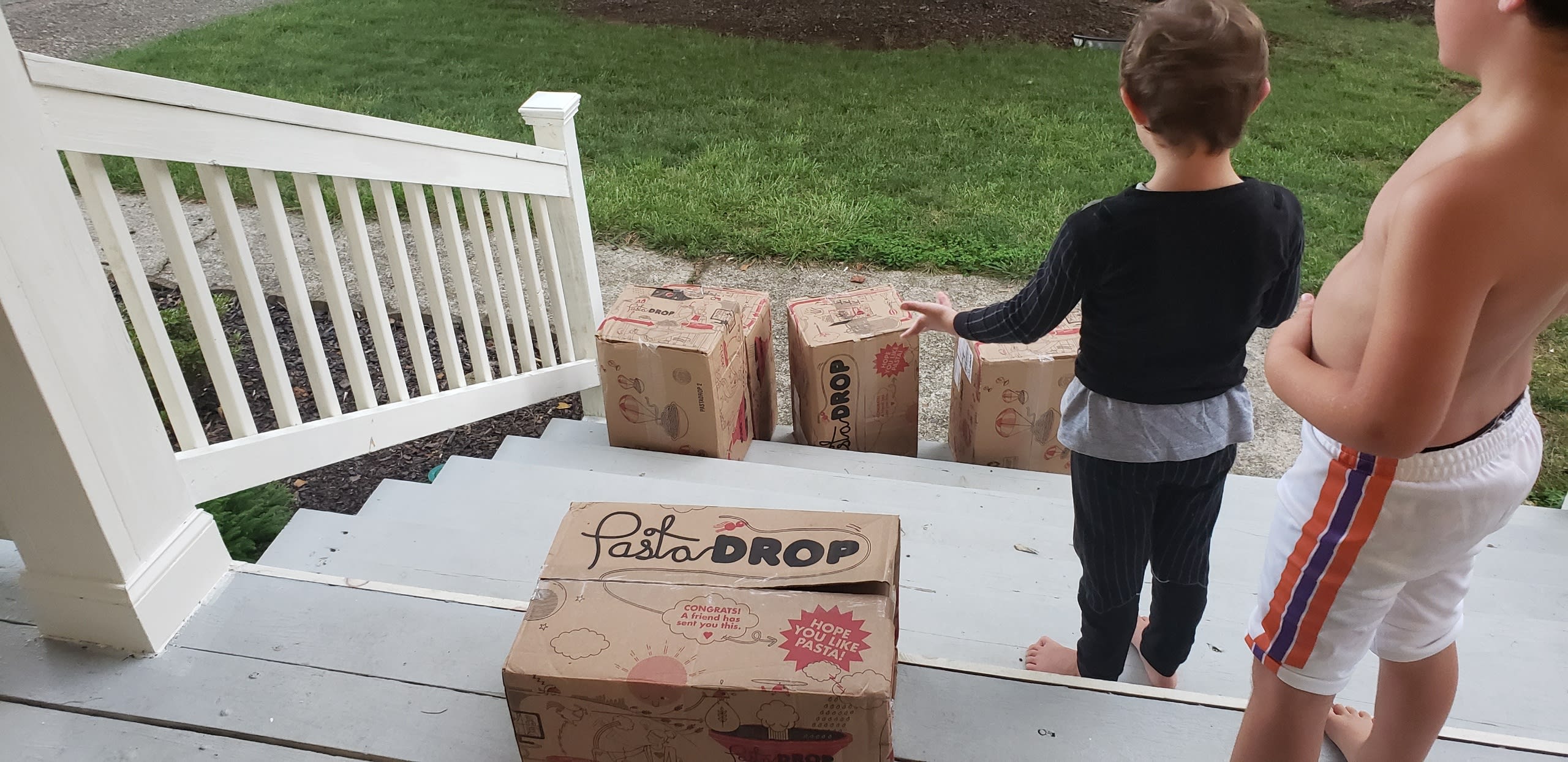 two boys looking at one hundred pounds of pasta