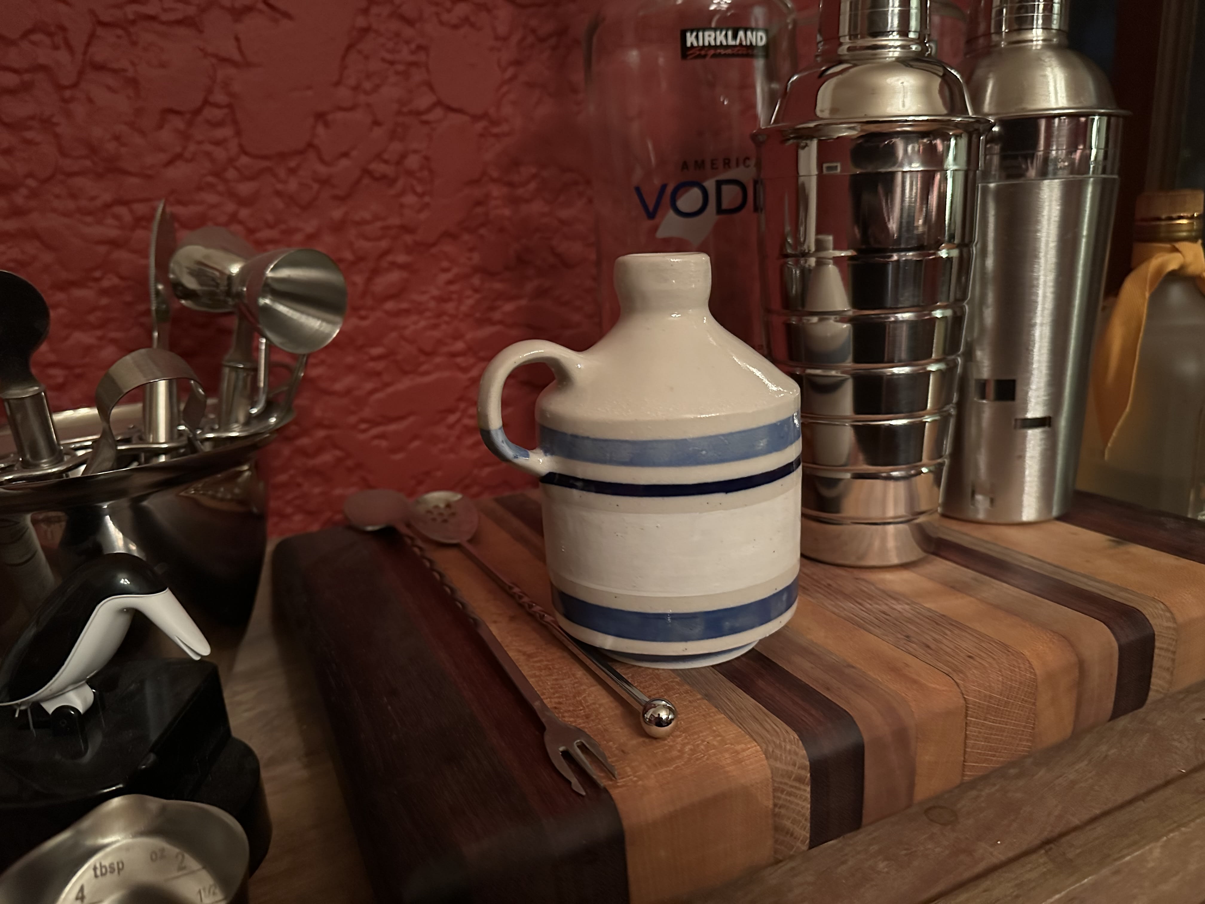 A small jug with blue and white stripes