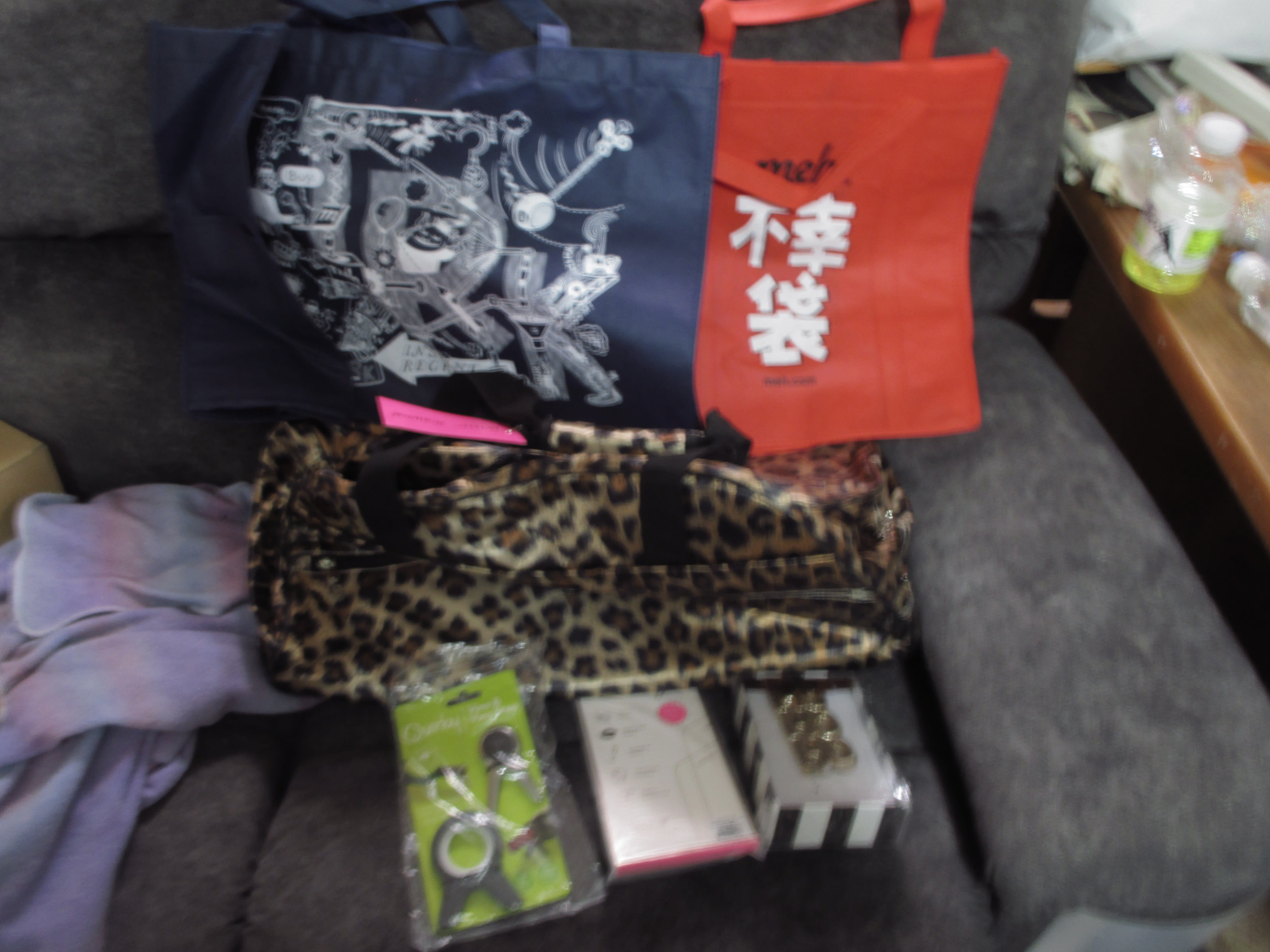 Fuku bag, IRK bag, iPhone X screen protector, HoHoHo ornament, Quirky wine bottle thingies, convertible leopard-print carry-on bag.