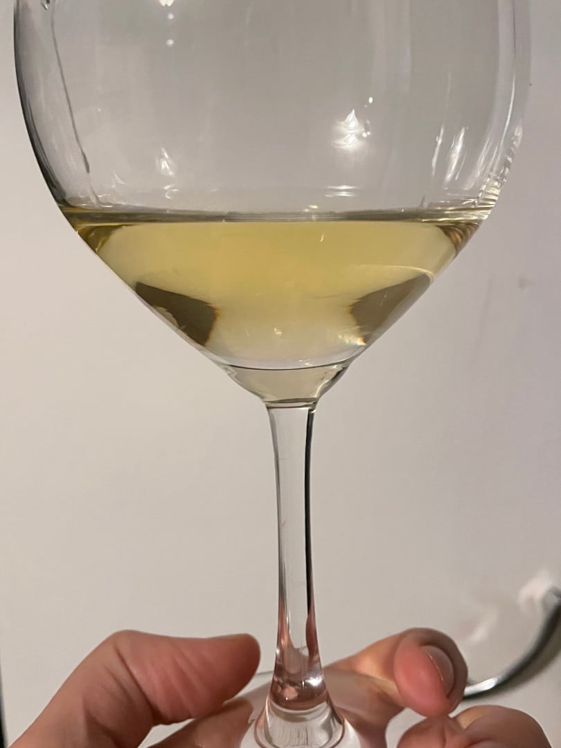 Wine in a glass against a white background, to show the color