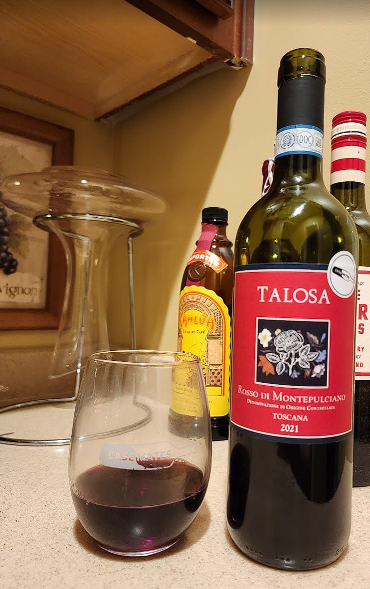 2021 Talosa bottle with front label and wine in a glass