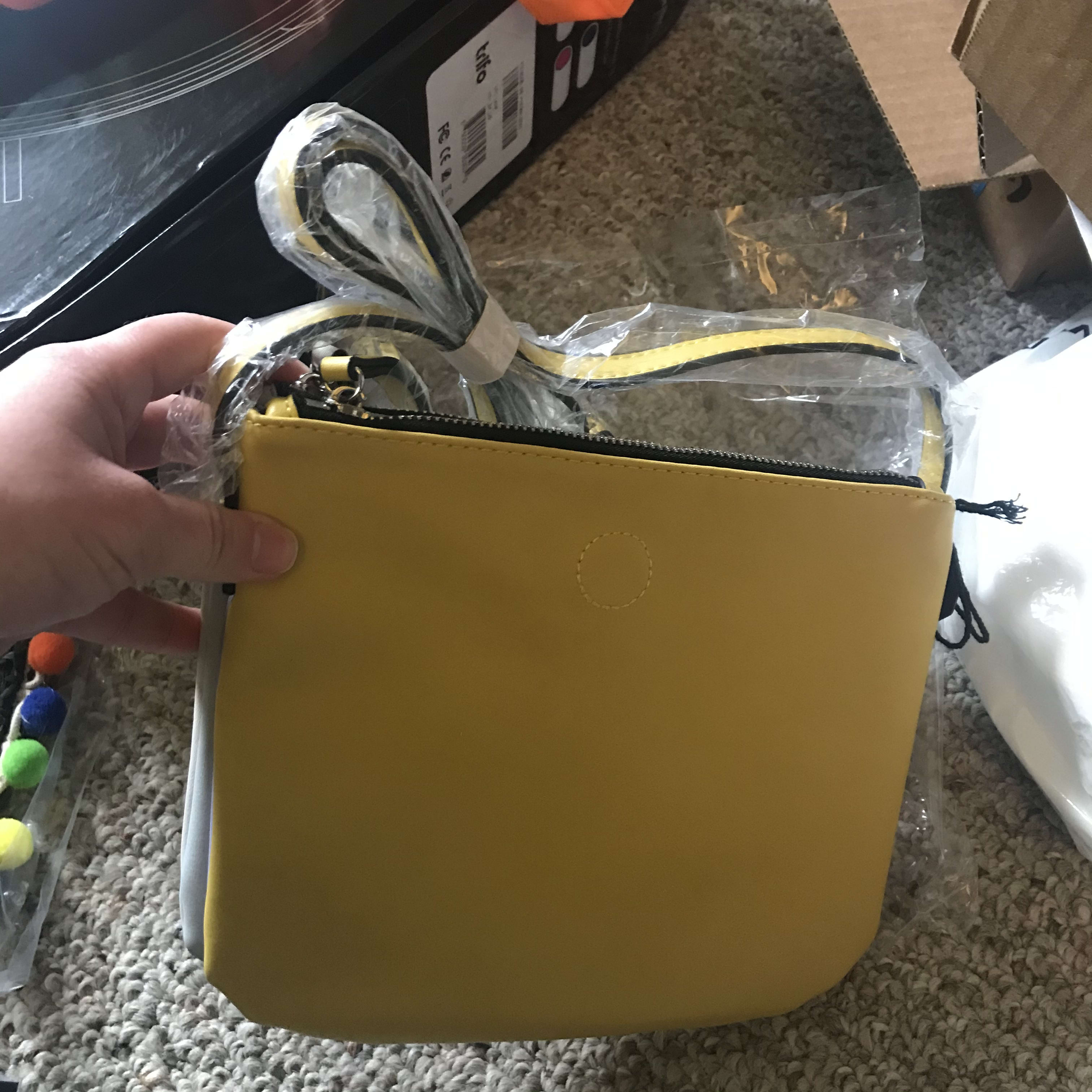 i got the lovely black zip pouch with Pom poms, Art Deco necklace, wet brush, Jessica Simpson necklace, and another lovely purse leather purse that can flip and change colors.