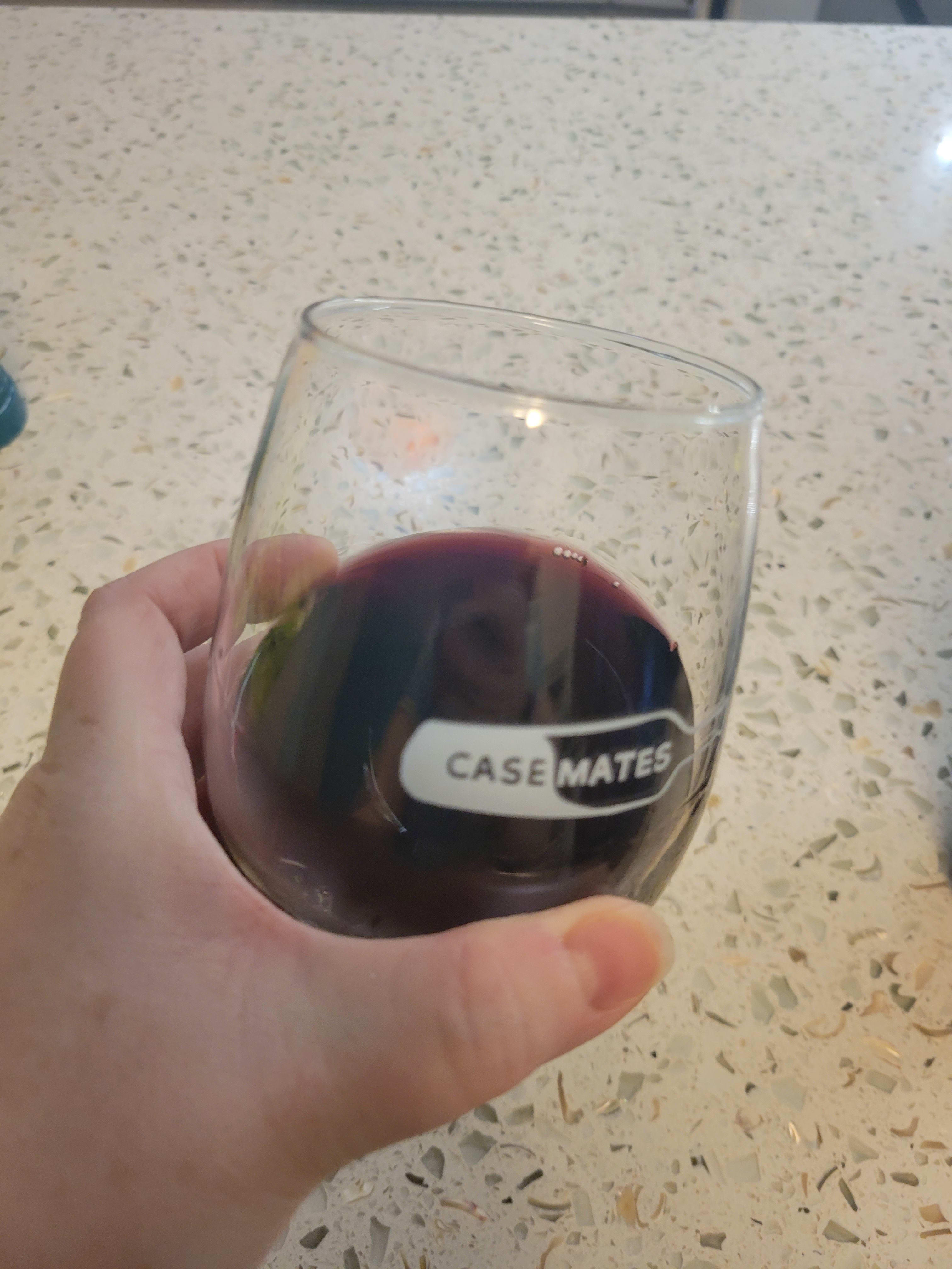 Red wine in glass against white background