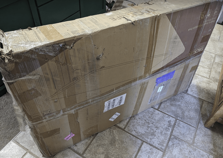 damaged box appears to hold motorized desk