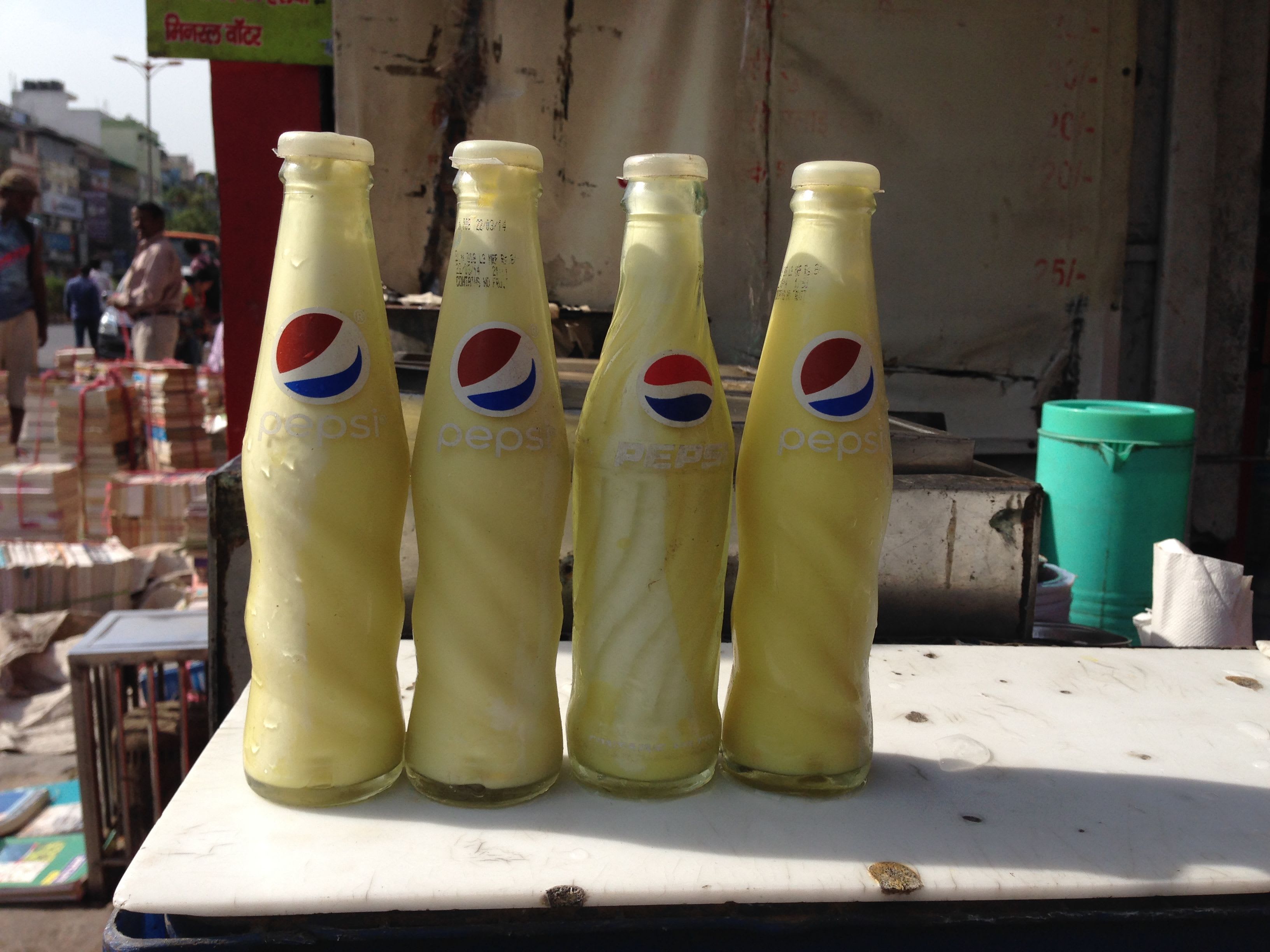 4 bottles of Pilk in a street scape