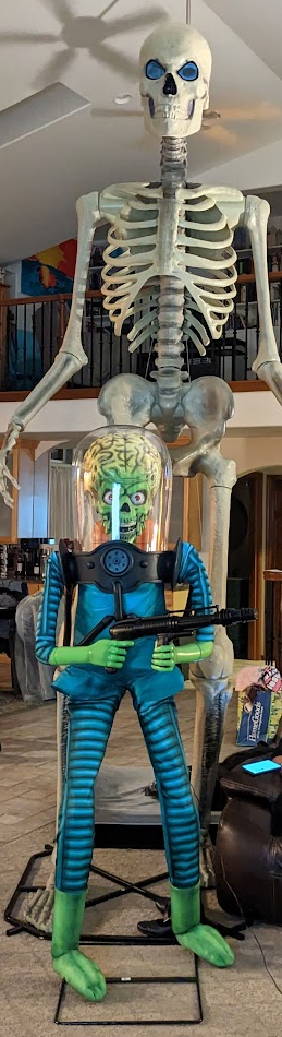 martian in front of 12-foot skeleton