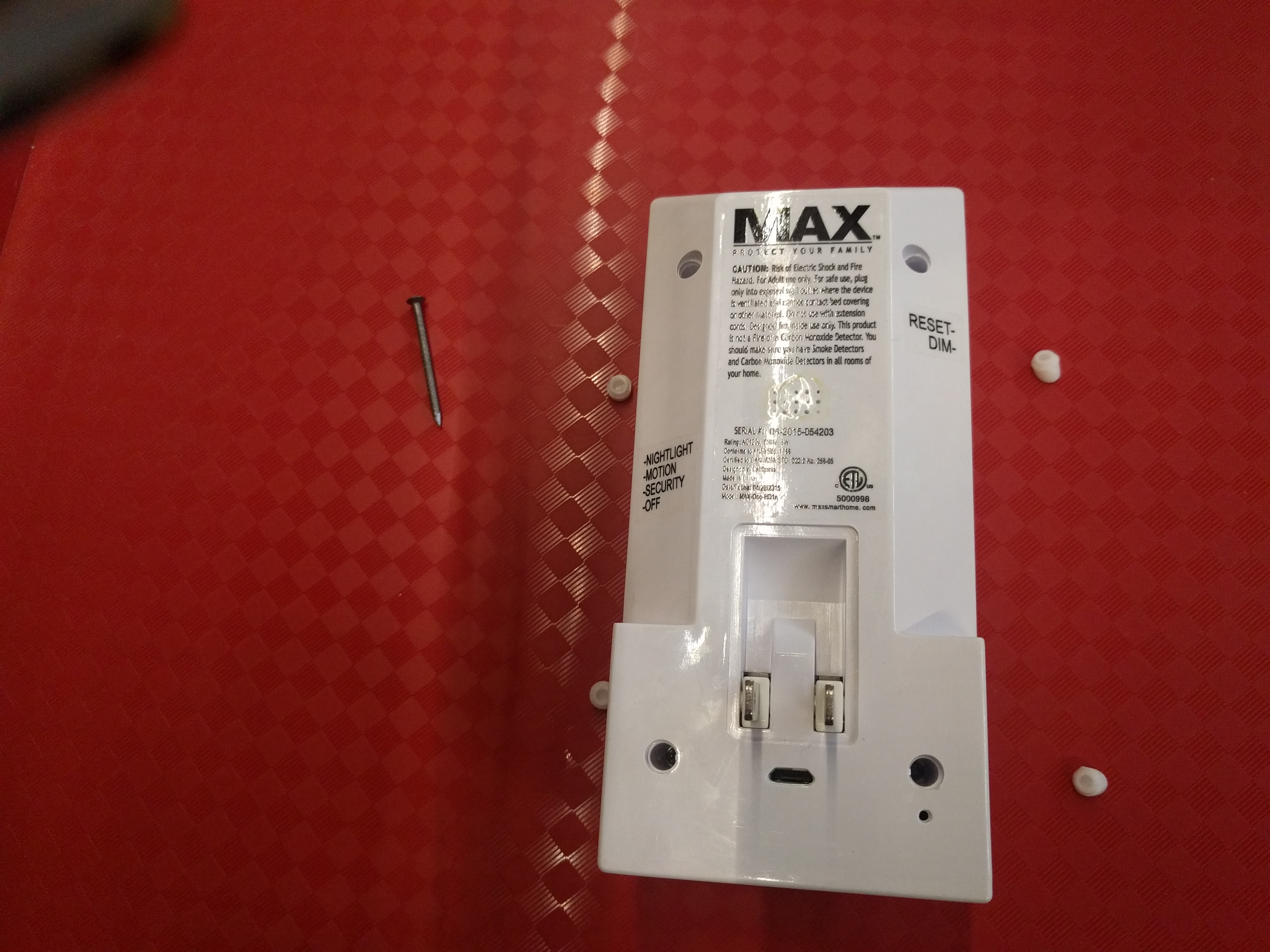 4 white rubber nubs, and the nail I used to pry them out