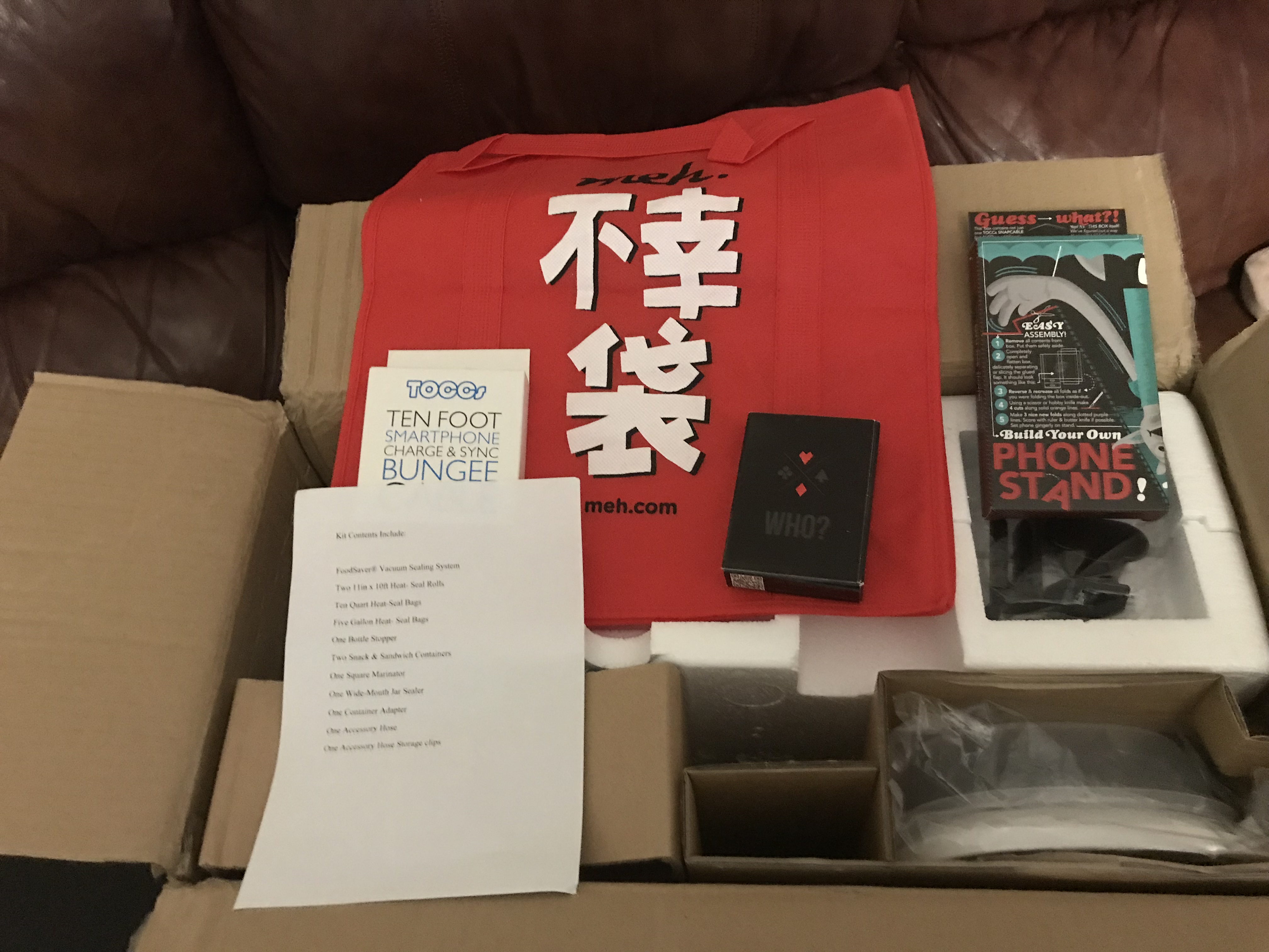 Food Saver, fuko bag, one box of Who playing cards, one ten foot smartphone charge and sync Bungee cord, and one build your own phone stand 