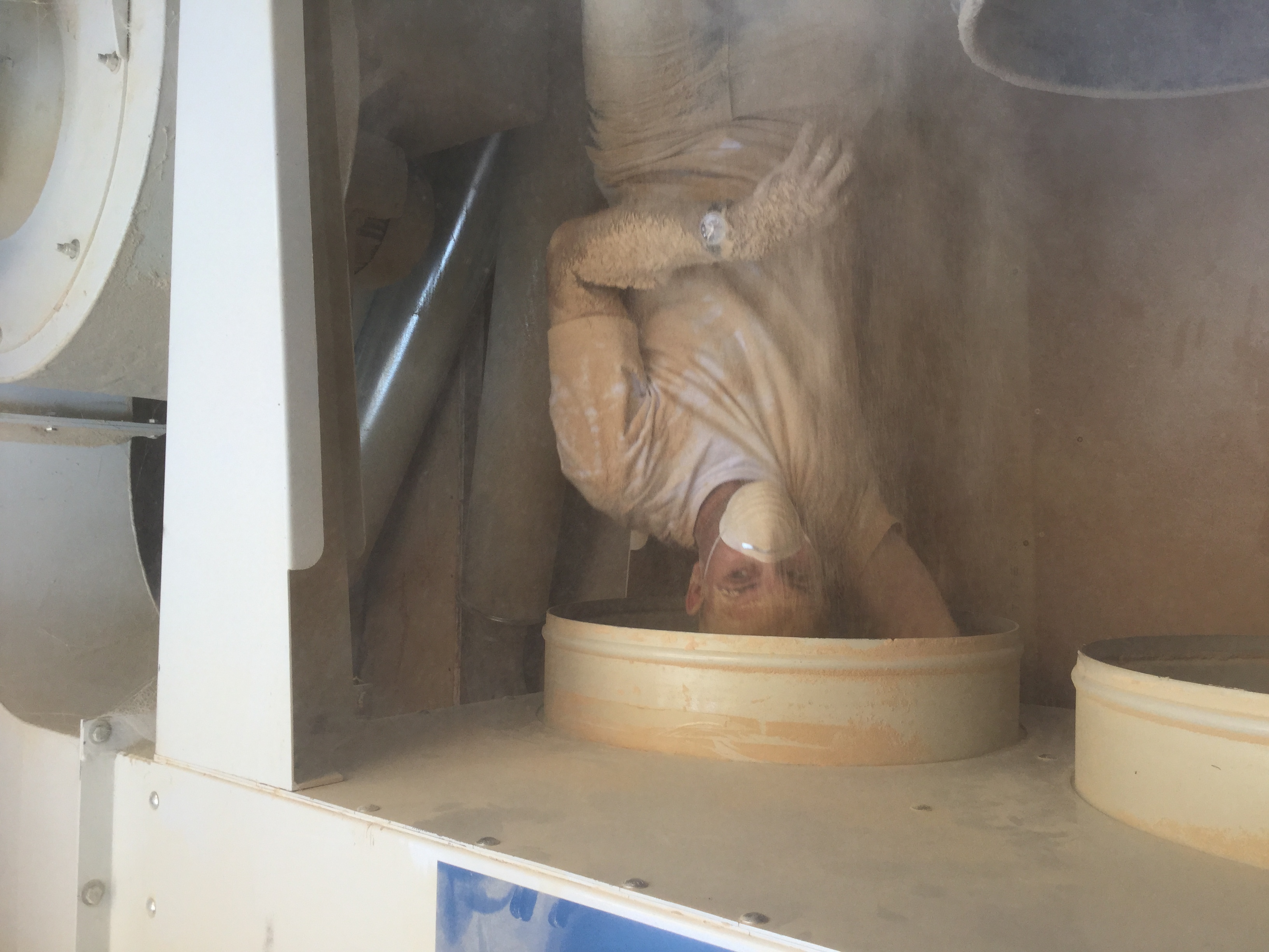 my brother cleaning out the sawdust evac bins